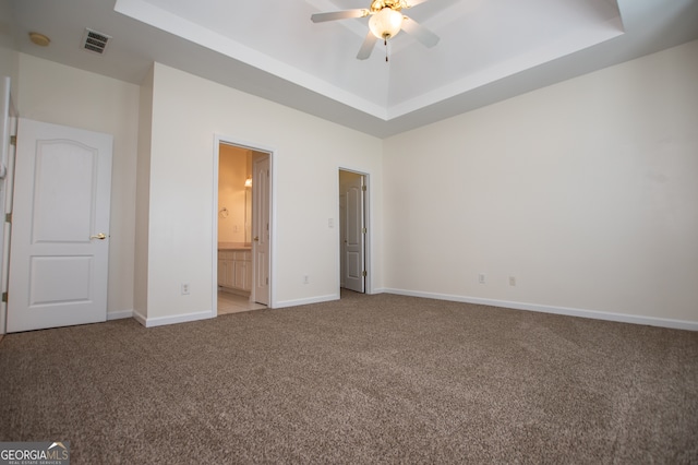 unfurnished bedroom featuring light carpet, ceiling fan, and ensuite bathroom