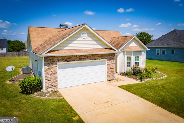 view of front of house with a front yard, a garage, and central AC unit