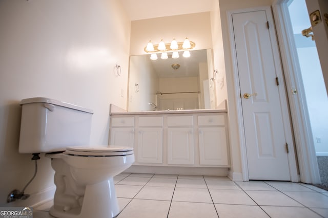 bathroom with vanity, toilet, and tile patterned flooring