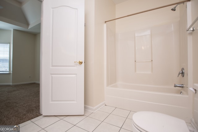 bathroom with shower / washtub combination, tile patterned flooring, and toilet