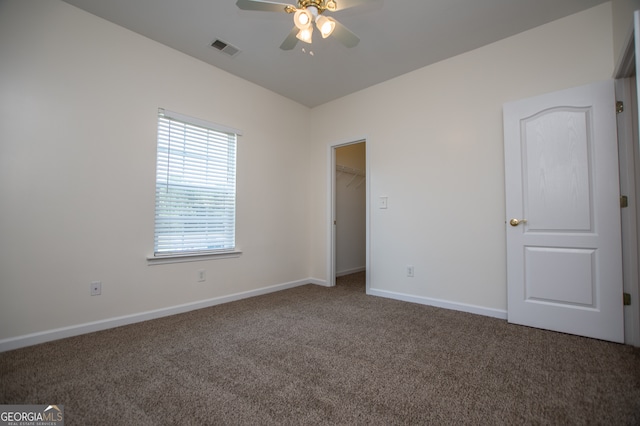 spare room featuring ceiling fan and carpet flooring