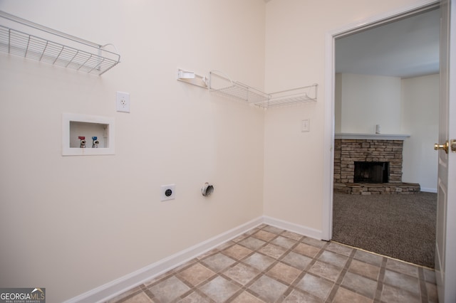 laundry room featuring light tile patterned floors, a fireplace, hookup for an electric dryer, and washer hookup