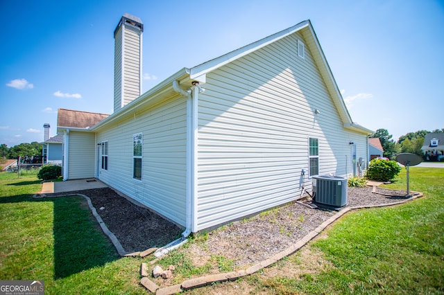 view of home's exterior featuring central AC and a lawn