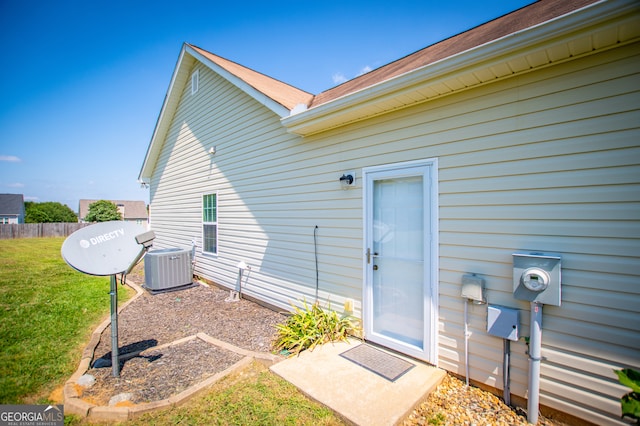 exterior space featuring central AC and a yard