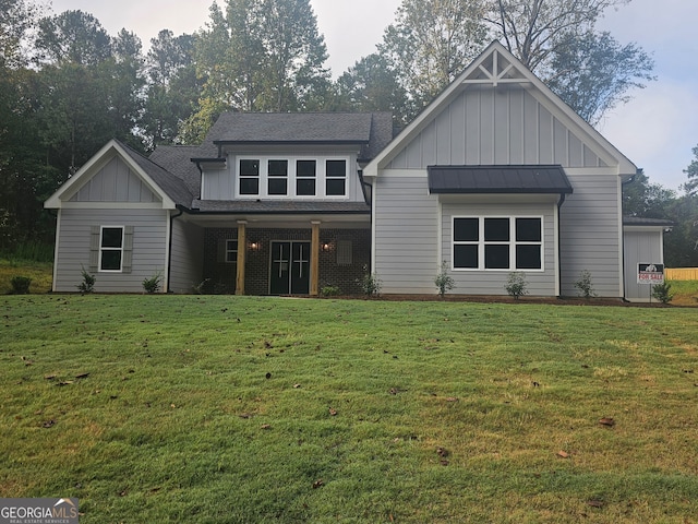 rear view of house featuring a yard