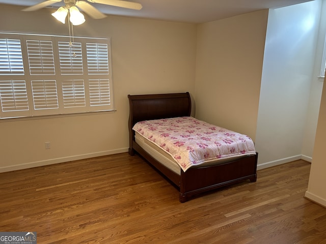 bedroom featuring hardwood / wood-style flooring and ceiling fan