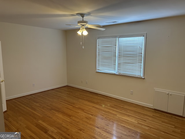 spare room featuring ceiling fan and hardwood / wood-style flooring