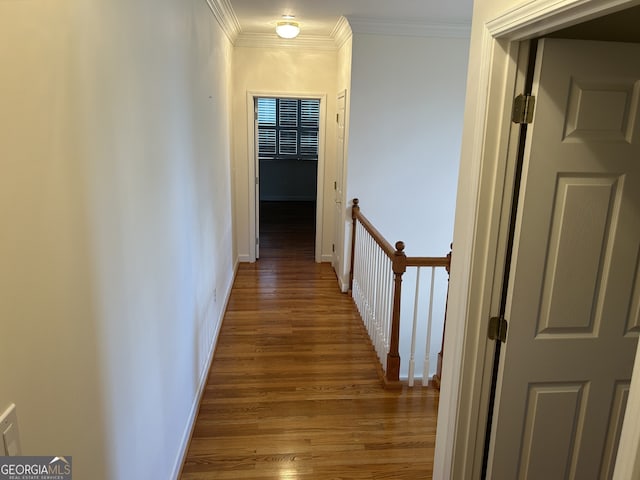 hallway featuring crown molding and hardwood / wood-style flooring