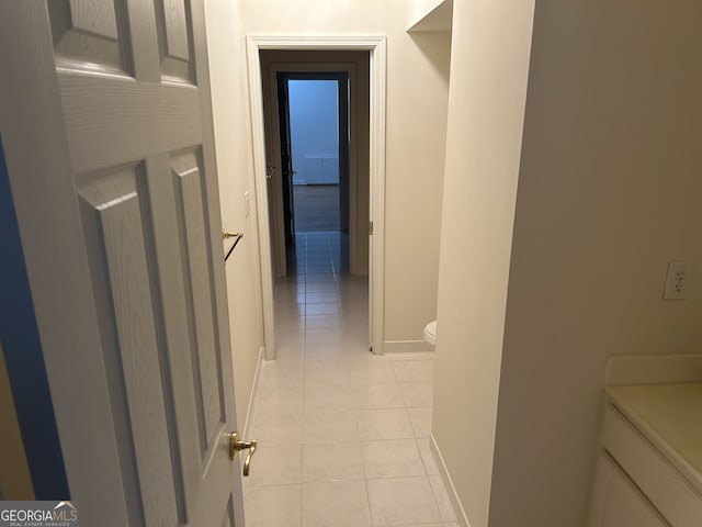 corridor with light tile patterned flooring