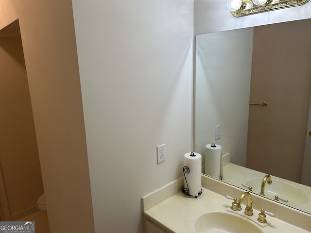 bathroom with vanity and toilet