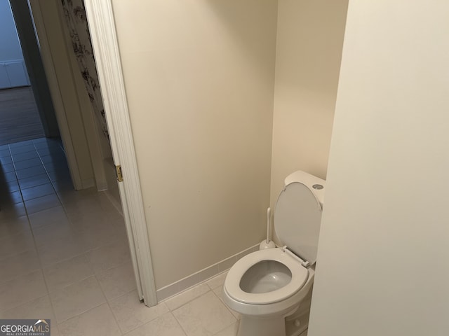 bathroom featuring toilet and tile patterned floors