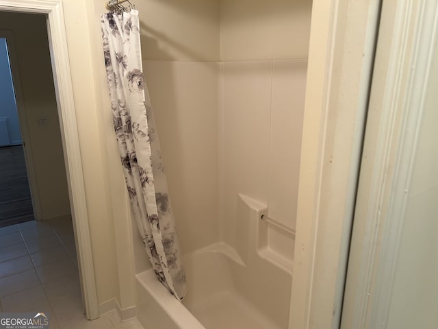 bathroom with shower / tub combo and tile patterned flooring