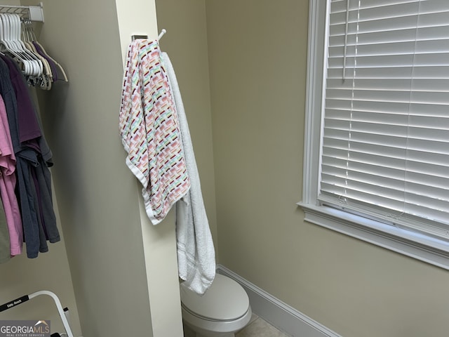 bathroom with tile patterned flooring and toilet