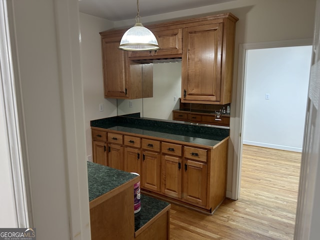 kitchen with light hardwood / wood-style flooring and hanging light fixtures