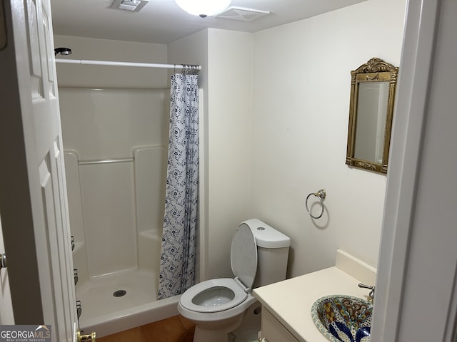 bathroom with vanity, toilet, walk in shower, and tile patterned flooring