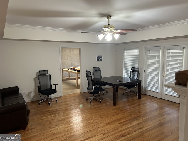 home office featuring wood-type flooring, french doors, ornamental molding, and ceiling fan