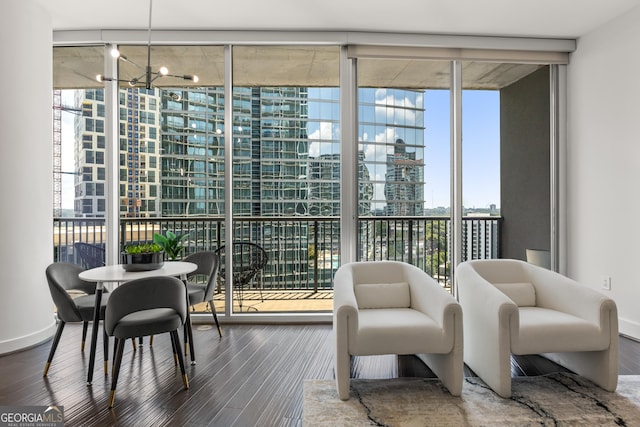 interior space with a wealth of natural light, hardwood / wood-style flooring, and a wall of windows