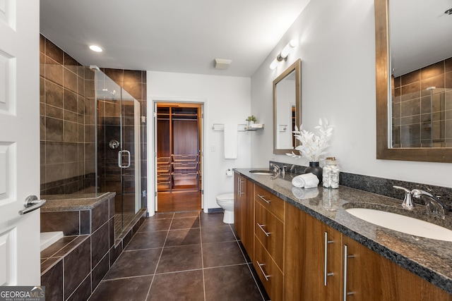 full bathroom with tile patterned flooring, vanity, shower with separate bathtub, and toilet