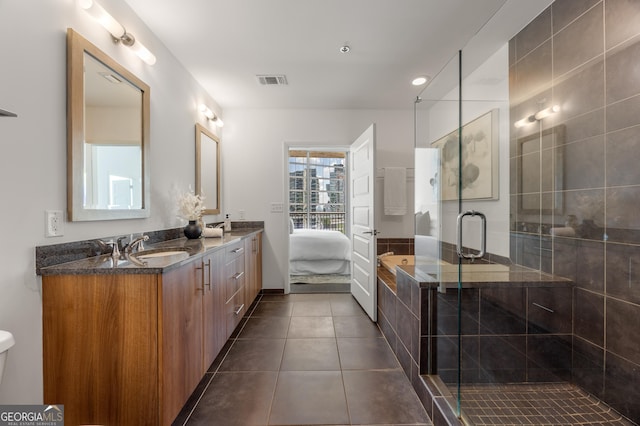 bathroom featuring tile patterned floors, vanity, and independent shower and bath