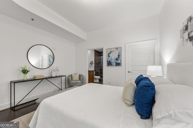 bedroom featuring wood-type flooring and connected bathroom