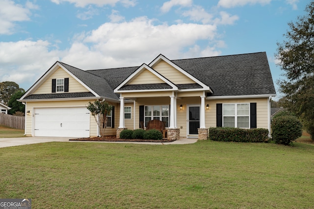 craftsman-style home with a front lawn, a garage, and covered porch