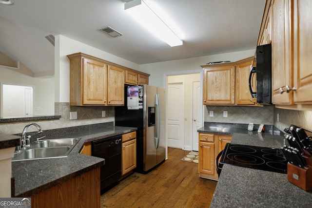 kitchen featuring decorative backsplash, black appliances, sink, and dark hardwood / wood-style floors