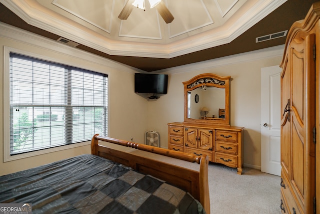 bedroom with ceiling fan, a raised ceiling, crown molding, and light colored carpet