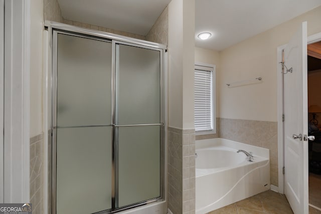 bathroom featuring tile walls, tile patterned flooring, and plus walk in shower