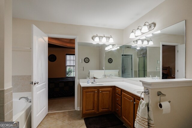 bathroom featuring vanity, tile patterned floors, and a bathing tub