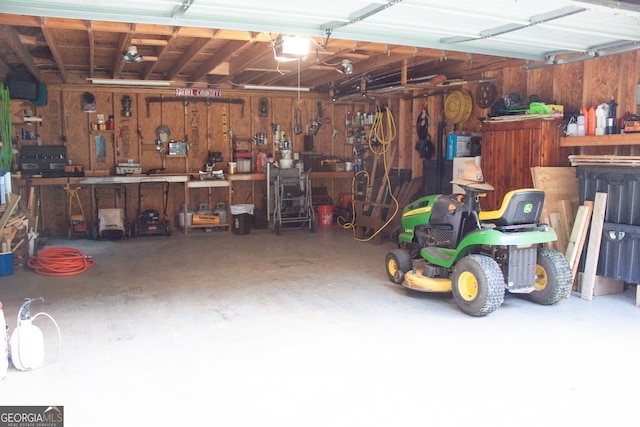 garage with a workshop area and a garage door opener