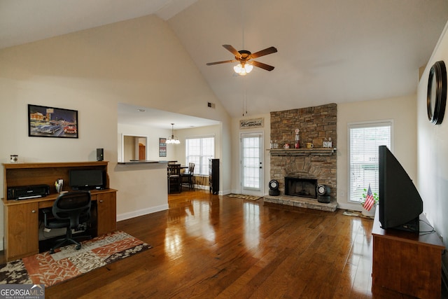 living room with high vaulted ceiling, dark wood-type flooring, ceiling fan with notable chandelier, and a fireplace