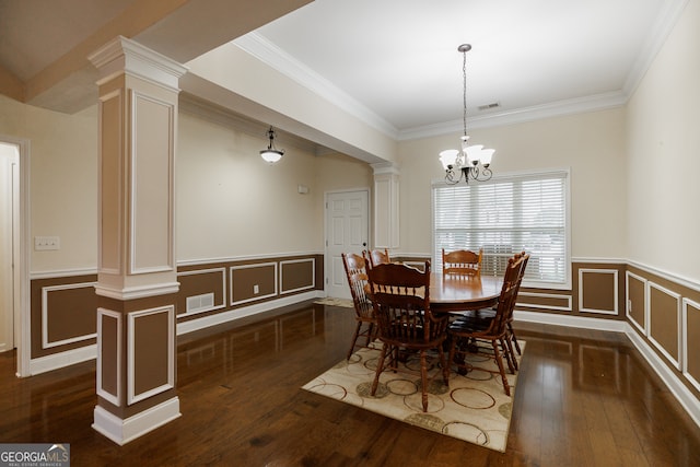 dining room with dark hardwood / wood-style flooring, decorative columns, and crown molding