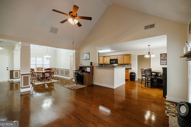 living room featuring high vaulted ceiling and dark hardwood / wood-style flooring