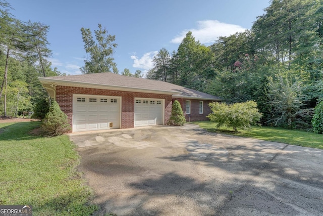 ranch-style house featuring a garage and a front lawn