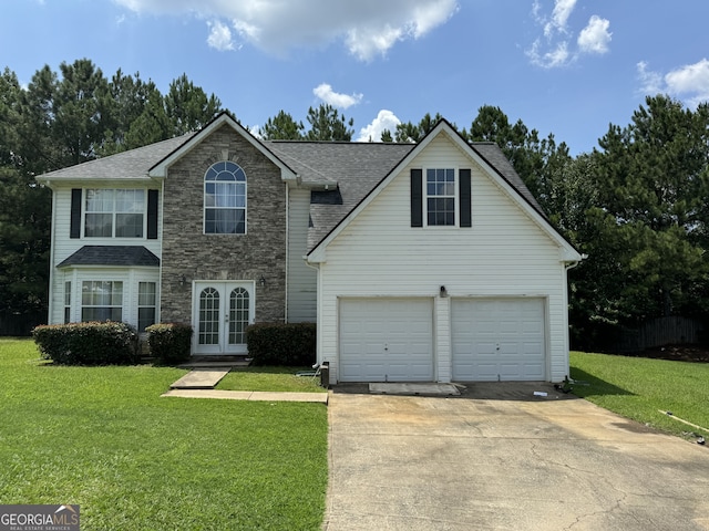 front facade featuring a garage, a front yard, and french doors