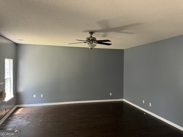 spare room with dark wood-type flooring, ceiling fan, and a textured ceiling