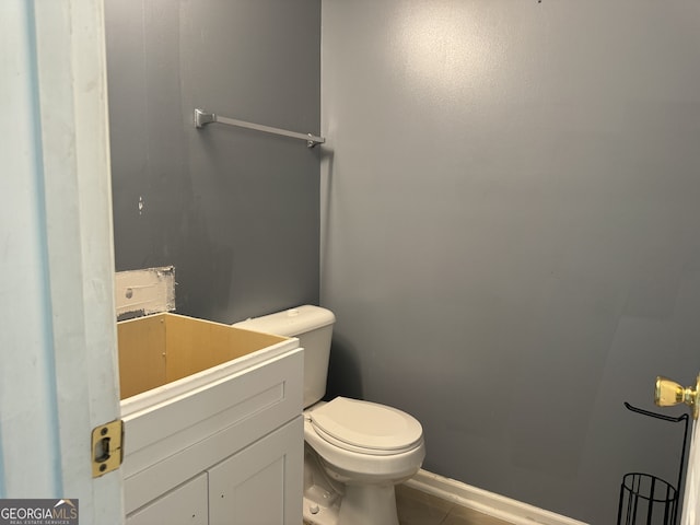 bathroom featuring tile patterned floors, toilet, and vanity