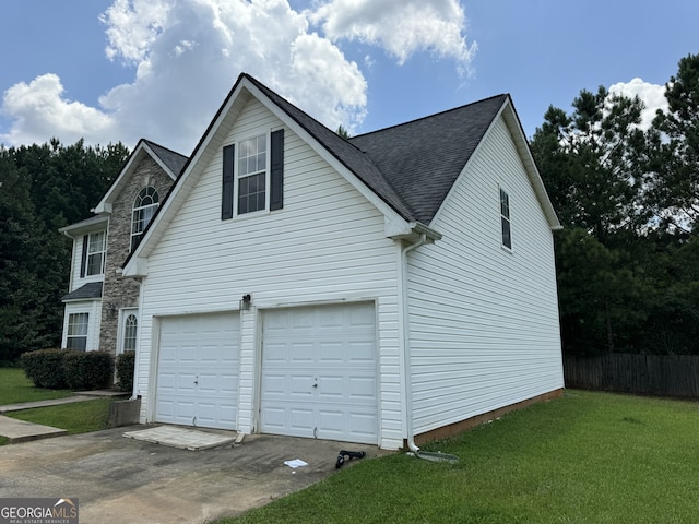 view of property exterior with a garage and a lawn