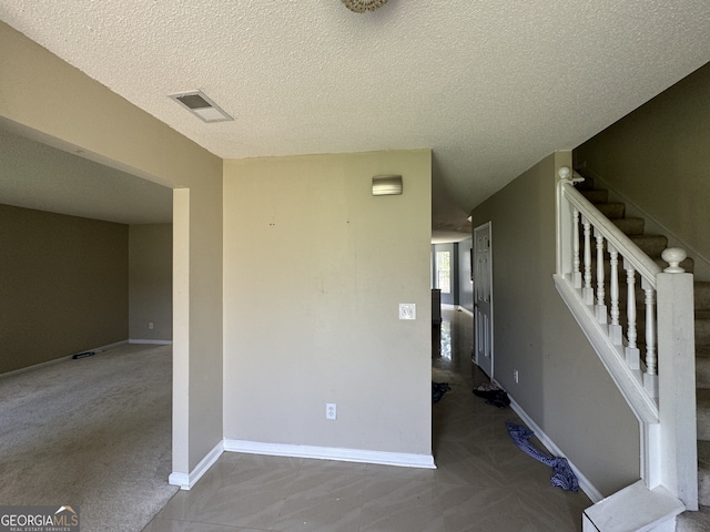 interior space with a textured ceiling