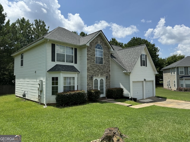 view of front of property with a garage and a front lawn