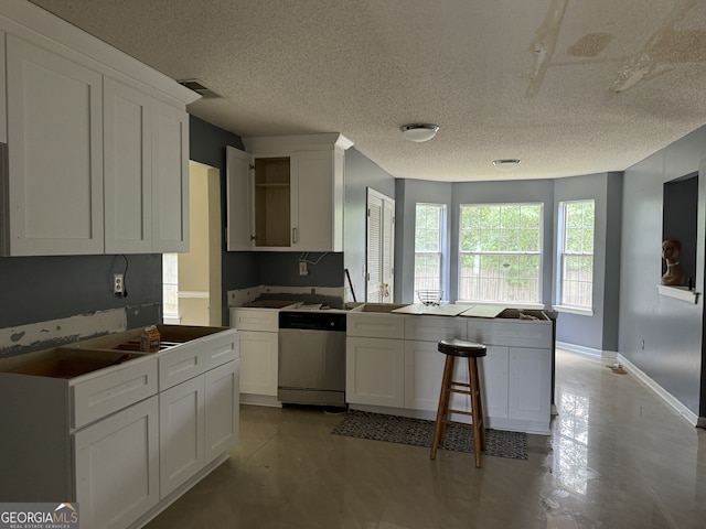 kitchen with white cabinetry, dishwasher, kitchen peninsula, and a textured ceiling