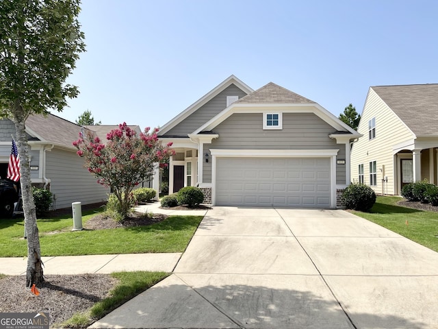 view of front of home featuring a garage and a front yard