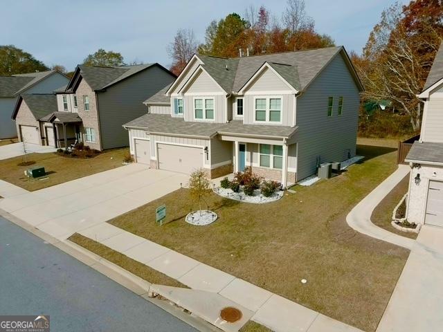 view of front of home with a front lawn and a garage