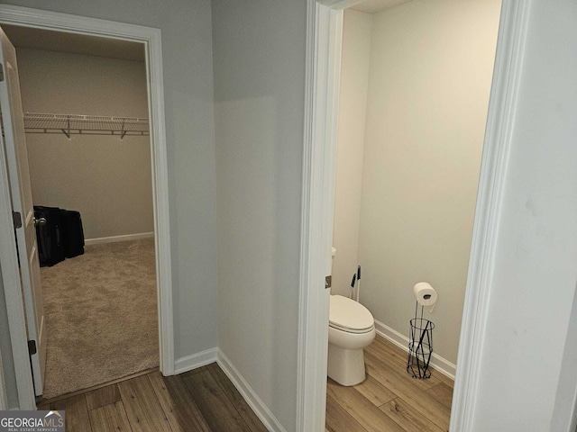 bathroom with toilet and hardwood / wood-style floors