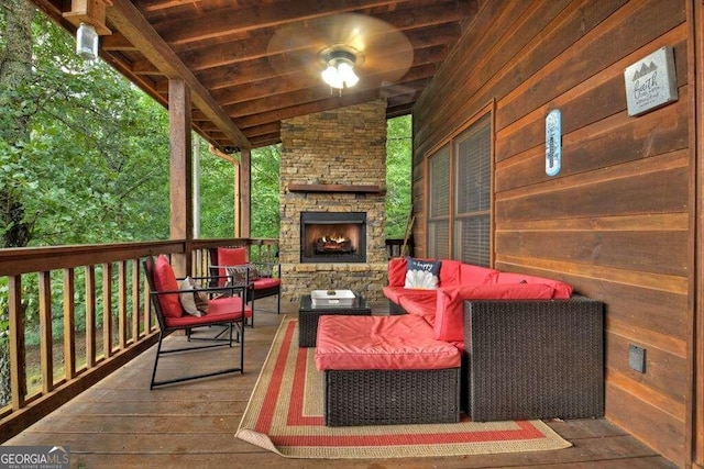 wooden deck featuring an outdoor living space with a fireplace