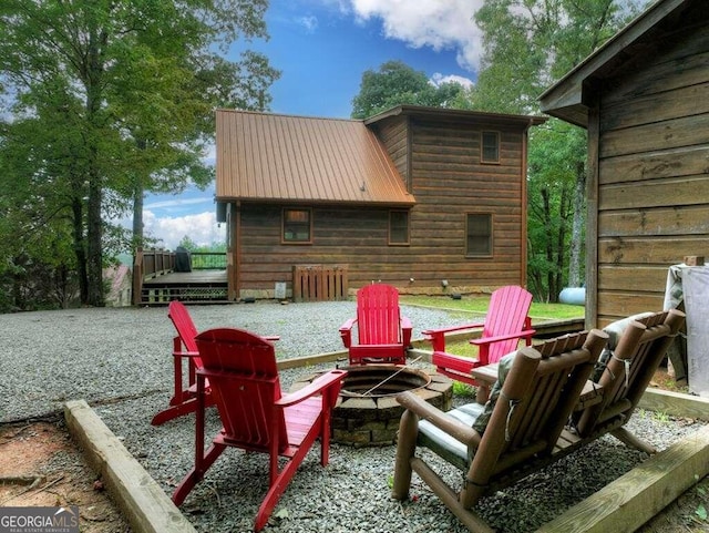 view of patio featuring a deck and an outdoor fire pit