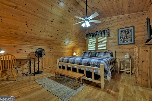 bedroom featuring wood walls, wood-type flooring, lofted ceiling, and wood ceiling