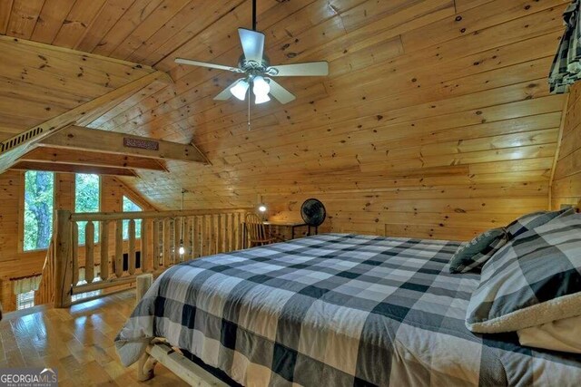 bedroom featuring wood-type flooring, ceiling fan, wooden walls, vaulted ceiling, and wood ceiling