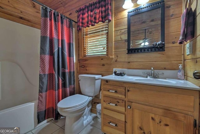 bathroom with vanity, tile patterned floors, ceiling fan, wooden walls, and toilet