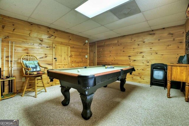 rec room featuring wood walls, light colored carpet, billiards, and a paneled ceiling